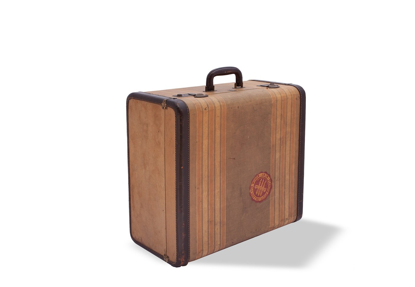Vintage striped suitcase standing on a white background