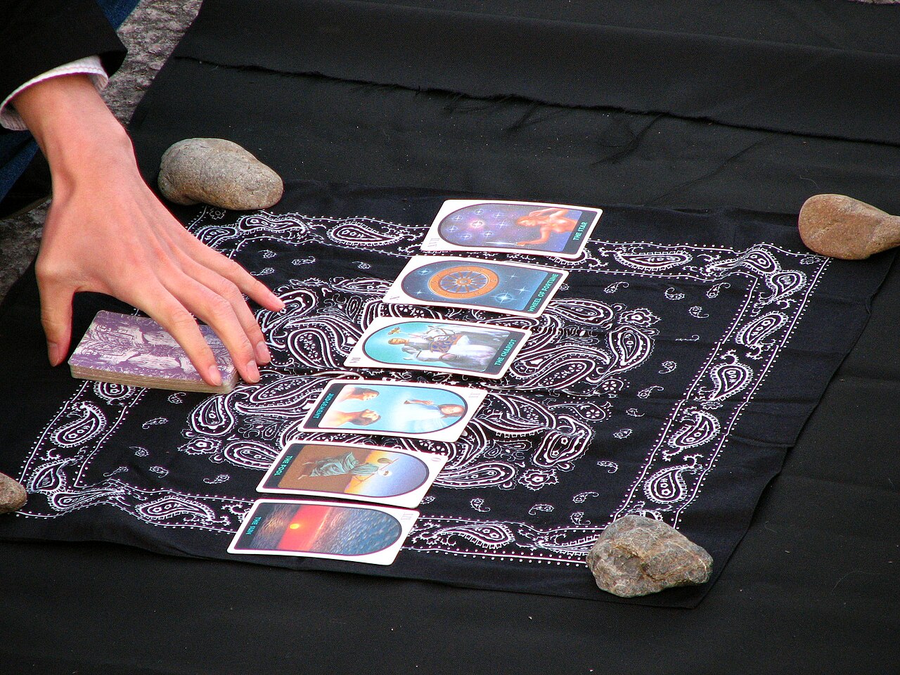 Tarot reader seated at a table during an in-person style reading